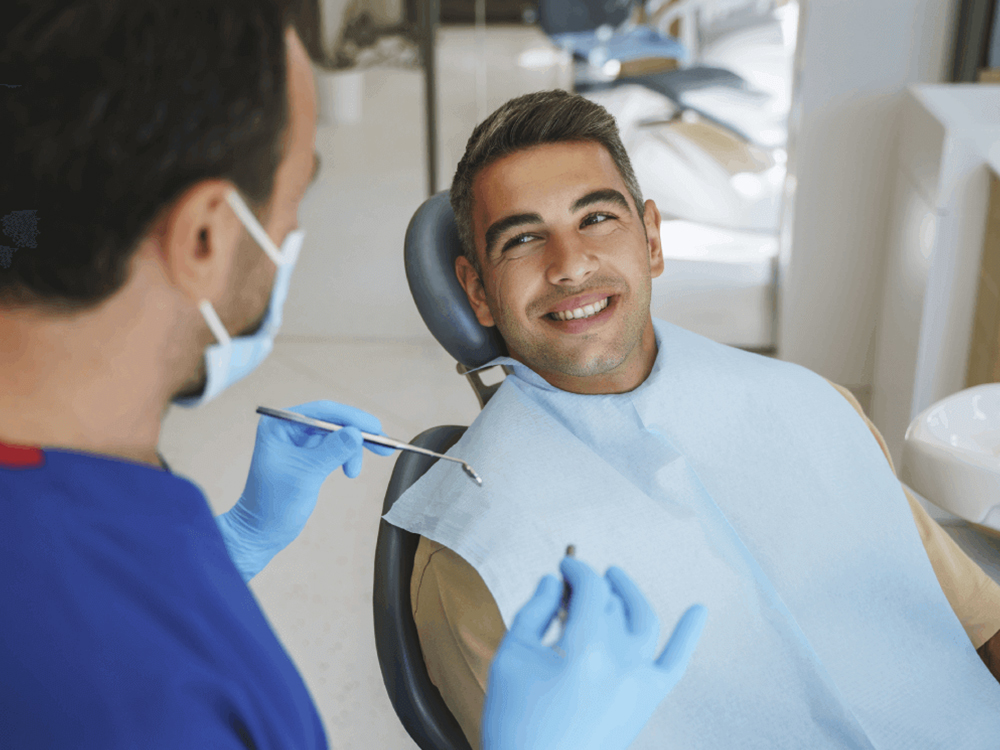 man smiling at dentist in dental chair