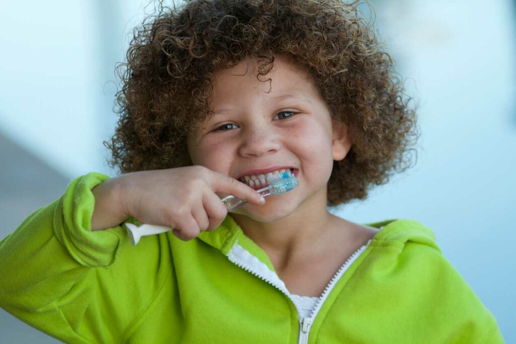 little girl brushing her teeth