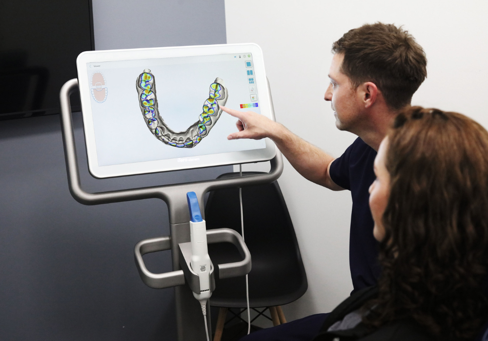 dr. castillo looking at cerec scanner