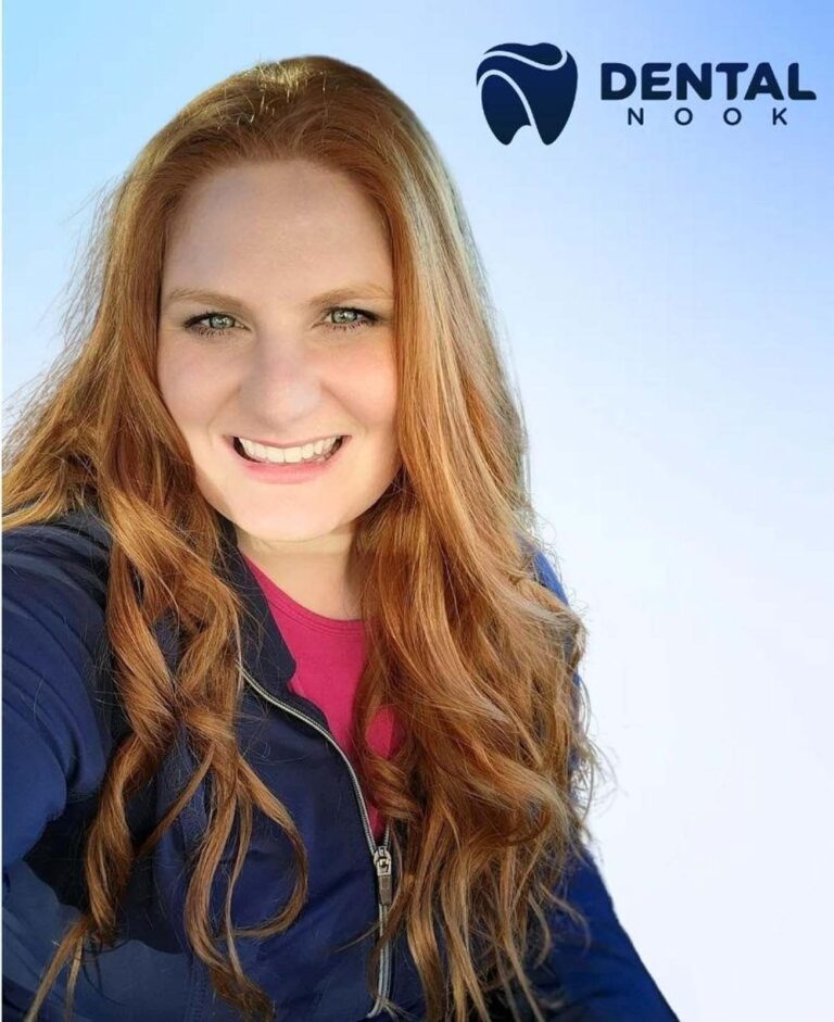 The image shows a woman with long, wavy, light brown hair wearing a dark blue jacket over a pink top. The top right corner features the logo "DENTAL NOOK" with a stylized tooth icon.